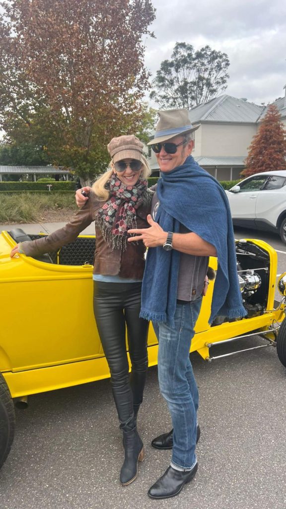 Craig and Vanessa Scammell in a yellow cruiser