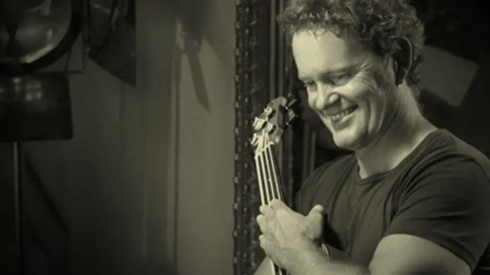 A picture of Craig McLachlan holding his beloved guitar