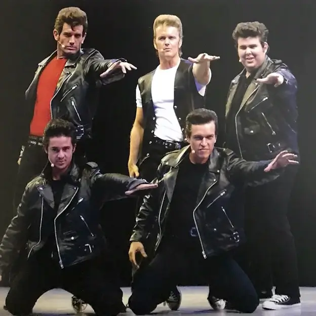 Craig McLachlan on stage with the cast of Grease The Arena Spectacular.